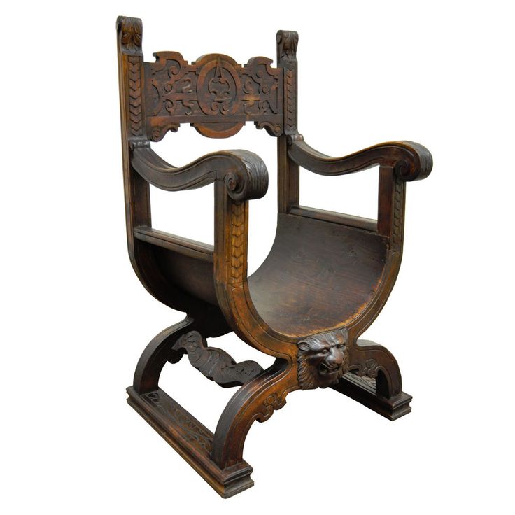 an old wooden chair with carvings on the back and seat, sitting in front of a white background