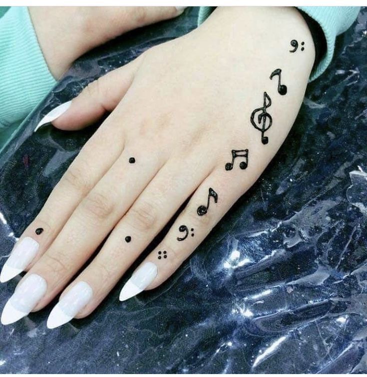 a woman's hand with musical notes on it