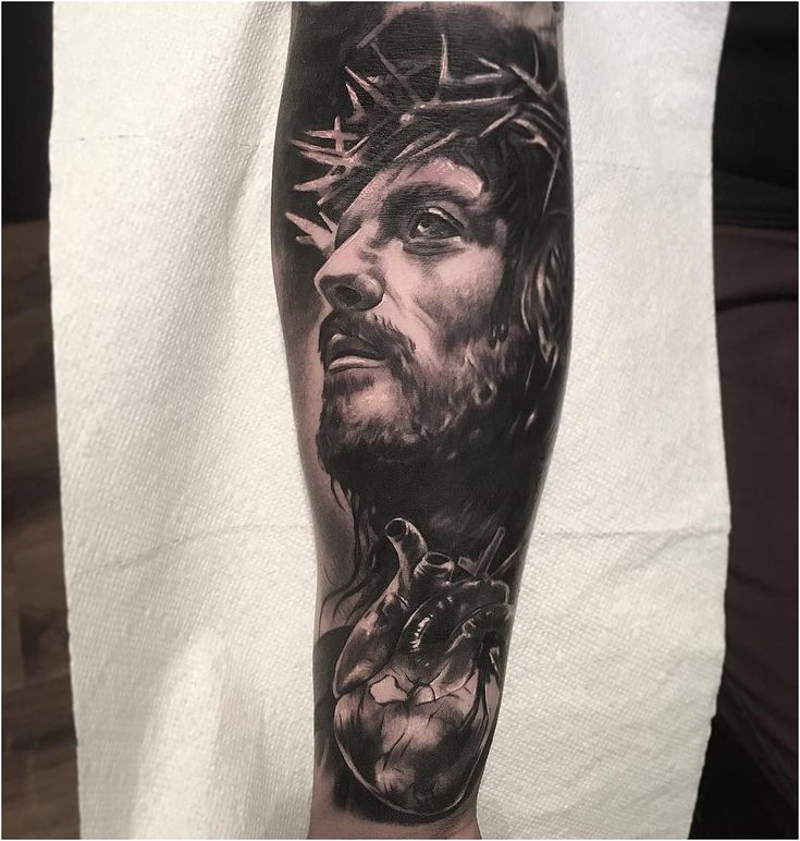 a man's arm with a tattoo of jesus and an eagle on it,