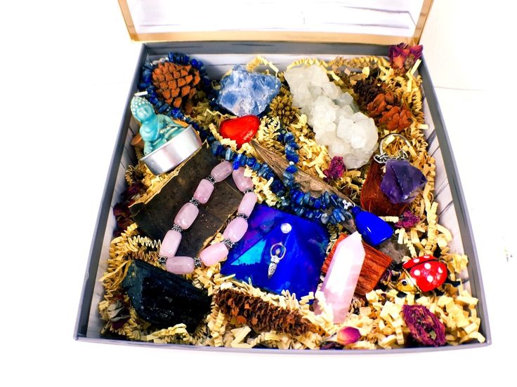 a box filled with lots of different types of rocks and glass items on top of each other