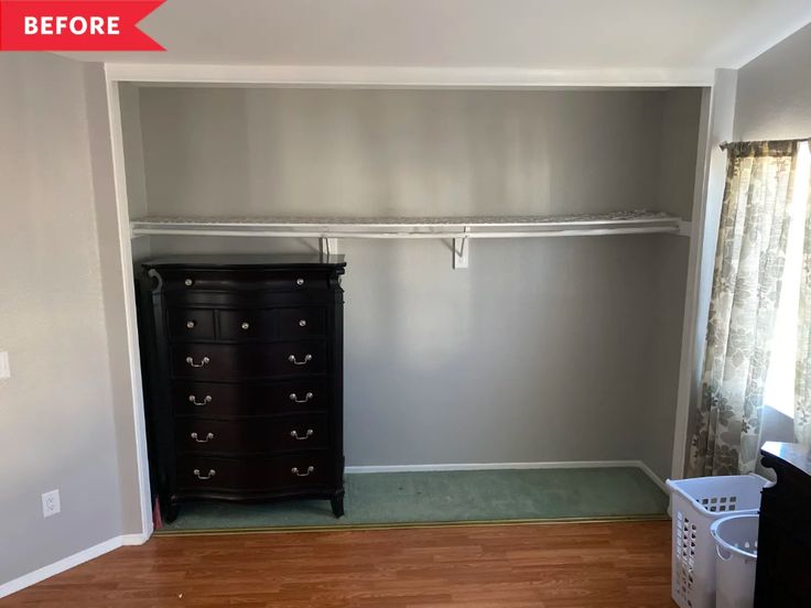 an empty room with a dresser and clothes rack