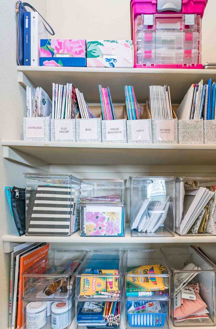 the shelves are filled with many different types of books and other things in plastic bins