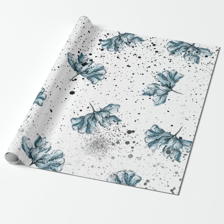 a white wrapping paper with blue leaves on it