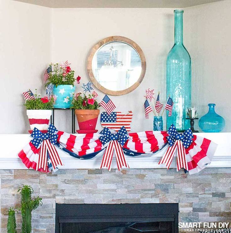 a fireplace mantel with american flags and wine bottles on it, along with potted plants