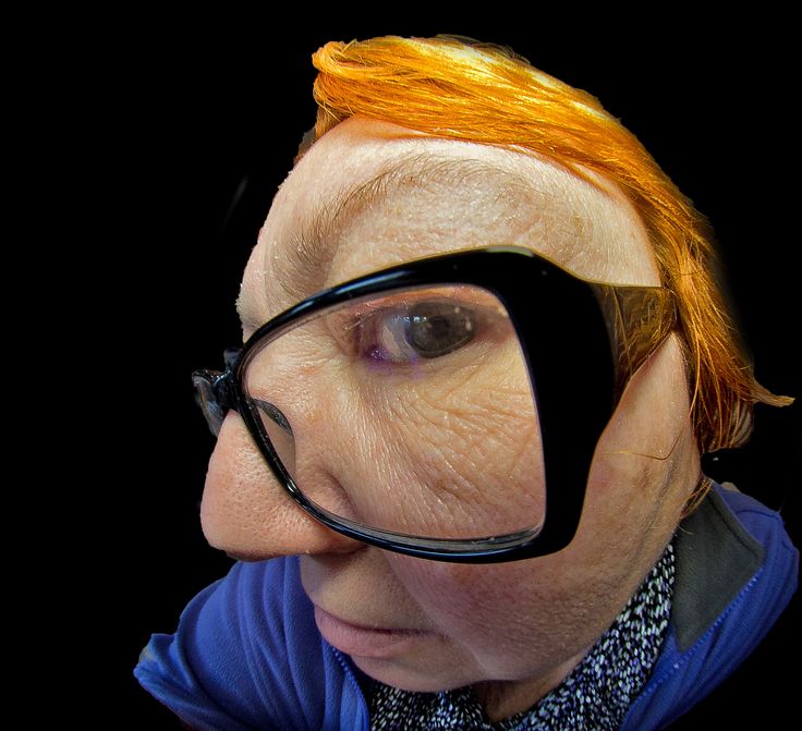 a woman with red hair and glasses on her face