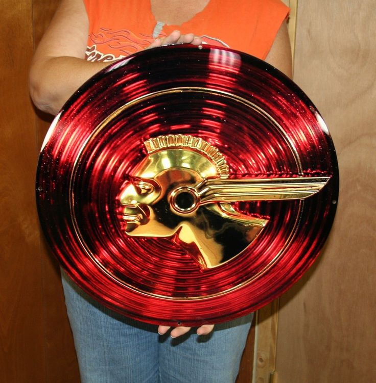 a person holding a red and gold plate