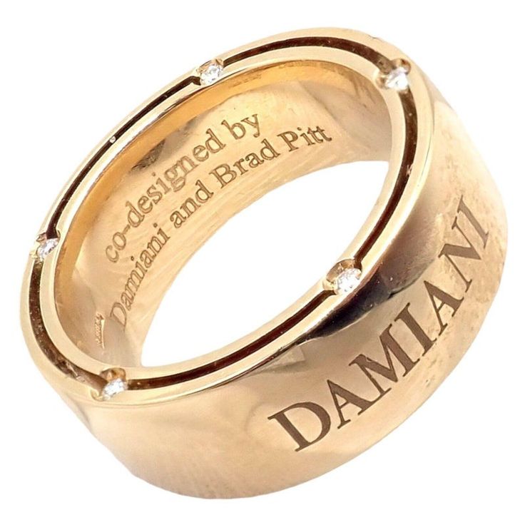 About This Piece: The Damiani Brad Pitt ring is a masterful blend of luxury and design. Crafted in exquisite 18k yellow gold, this size 5.5 band radiates opulence with 10 sparkling diamonds embedded within. The wide band profile elevates its prominence on the wearer's finger. Co-designed by Brad Pitt, it carries not just the weight of precious metals and gemstones but also the prestige of a celebrity touch, making it a statement piece for any collection. Retail Price: $3,590  Damiani Box + Paper Designer Yellow Gold Brilliant Cut Diamond Ring, Designer Yellow Gold Diamond Ring With Brilliant Cut, Designer Rose Gold Rings For Anniversary, Luxury Gold Diamond Ring For Formal Occasions, Luxury Yellow Gold Diamond Ring With Pave Setting, Designer Rose Gold Diamond Ring For Anniversary, Luxury Yellow Gold Diamond Ring For Anniversary, Designer Yellow Gold Diamond Ring With Vvs Clarity, Luxury 14k Stamped Engraved Promise Ring