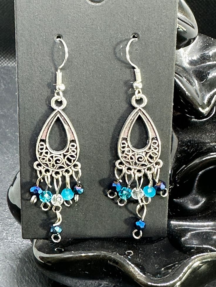 Handmade earrings with blue faceted beads. The earrings are 7 cm long. Light Blue Beaded Dangle Earrings For Party, Blue Bohemian Crystal Earrings, Bohemian Blue Crystal Earrings, Blue Metal Beaded Drop Earrings, Turquoise Teardrop Earrings With Faceted Beads, Metal Beaded Earrings With Faceted Beads For Gifts, Blue Metal Beaded Dangle Earrings, Handmade Blue Beaded Metal Earrings, Blue Beaded Metal Earrings