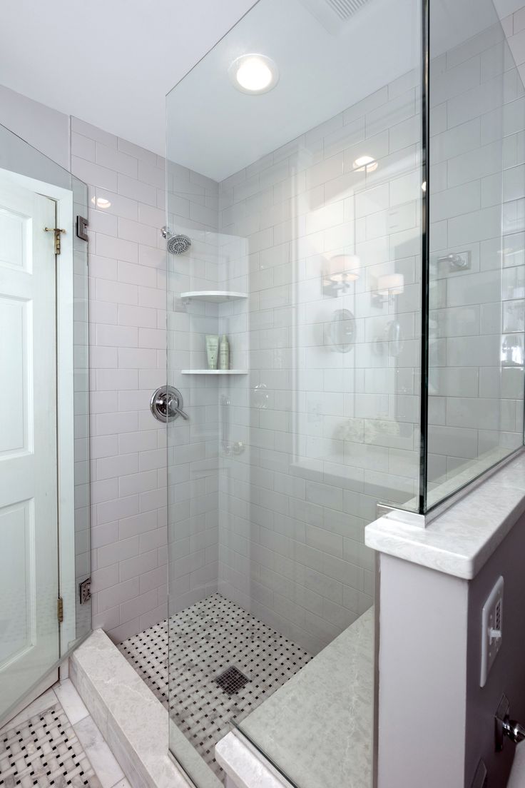 a walk in shower sitting inside of a bathroom