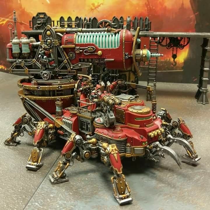 a red and gold robot is sitting on the ground