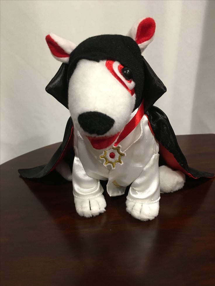 a stuffed animal dog sitting on top of a wooden table