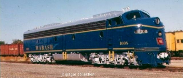 a blue train engine sitting on the tracks