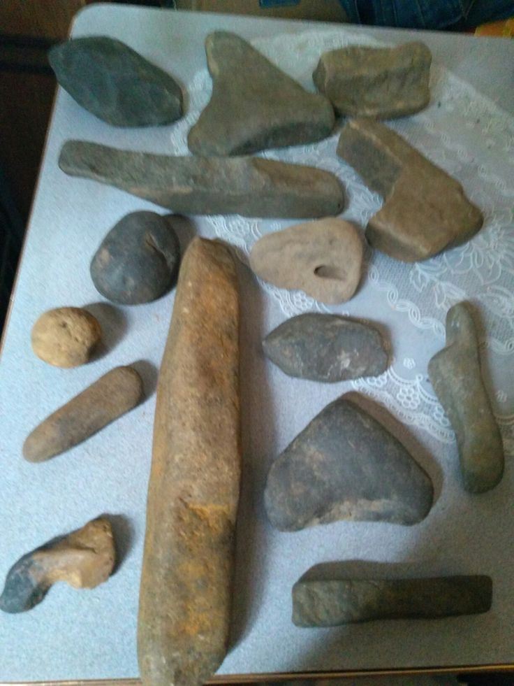 several different types of rocks and tools on a sheet of white paper next to each other