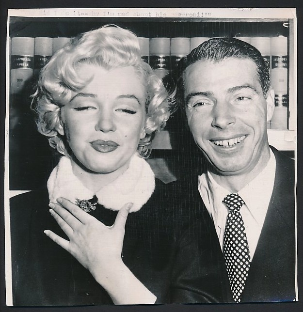 an old black and white photo of a man and woman posing for the camera together