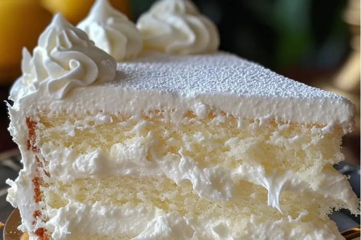 a slice of cake with white frosting on a plate