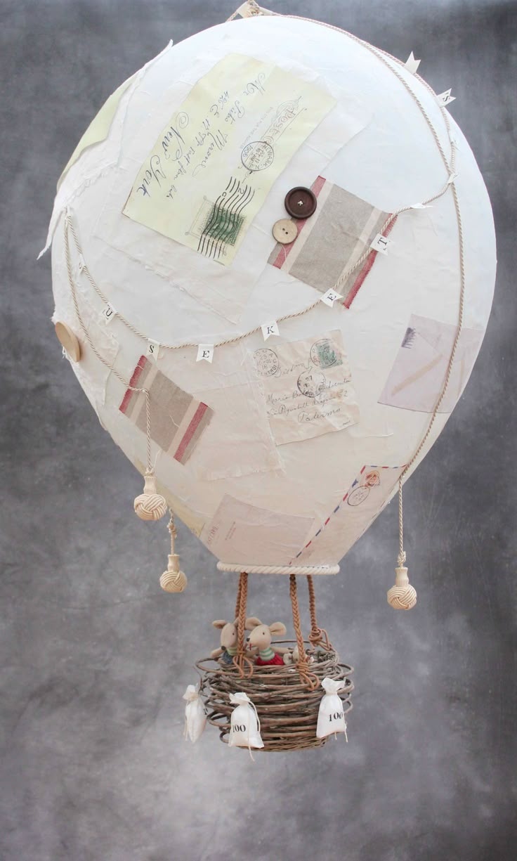 a white hot air balloon with lots of papers on it's back and sides