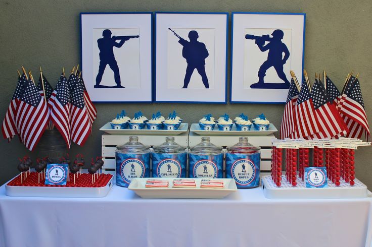 the table is set up with american flags and cupcakes