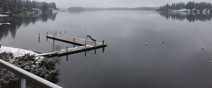 a dock on a lake in the middle of winter