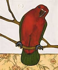 a red bird sitting on top of a tree branch