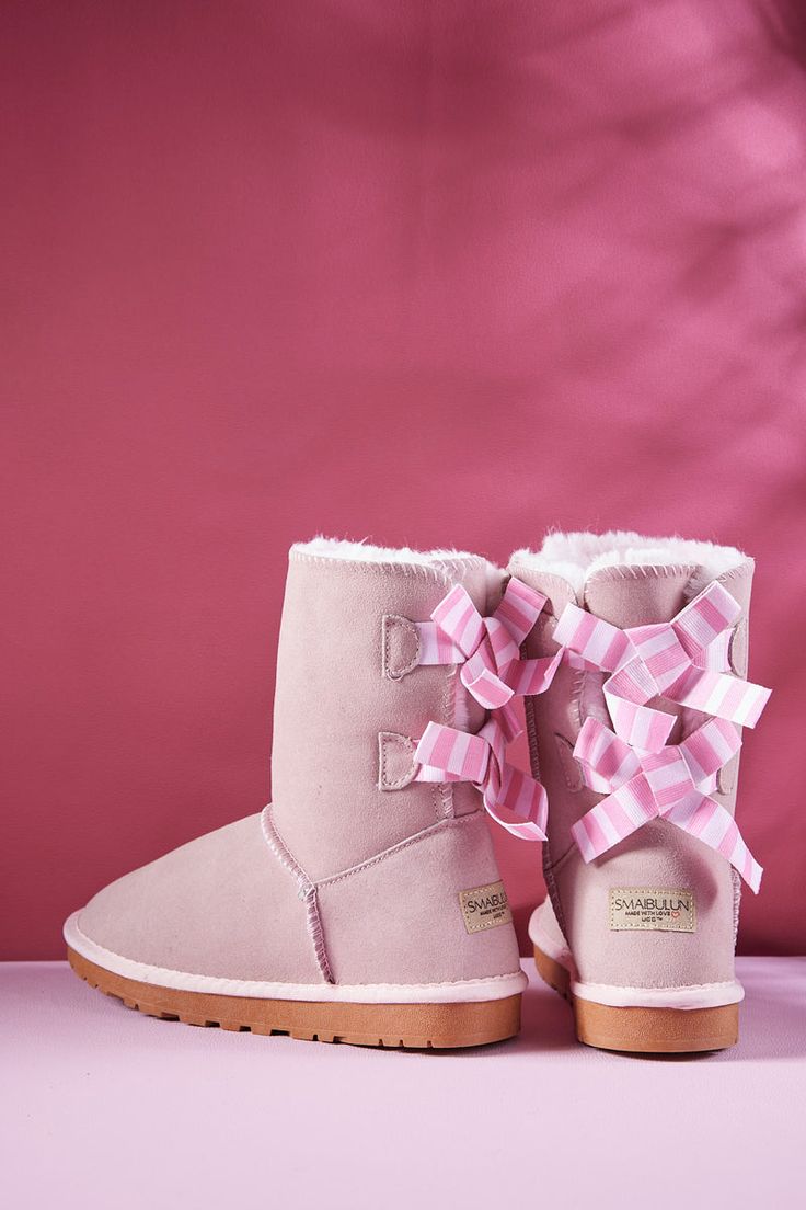 Introducing Smaibulun's Ugg Serenity Striped Ribbon Bow Shearling Boots, the perfect combination of sophistication and style. Crafted from the finest soft suede materials to provide you with an indulgent experience, these soft pink boots feature a distinctive stripe ribbon and bow design that exudes luxury. Comfort and quality guaranteed. 1'' heel 7.6'' shaft 15.6'' circumference Pull-on Lightly padded footbed Suede upper Faux fur lining Man-made sole Pink Bailey Bow Ugg, Reindeer Headband, Bailey Bow, Pink Boots, Striped Ribbon, Shearling Boots, Bow Design, Suede Material, Dress Jewelry