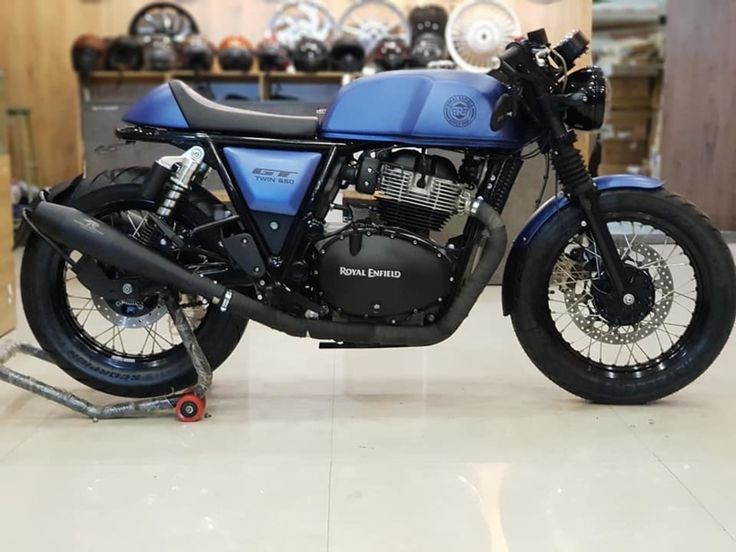 a blue motorcycle is parked in a showroom