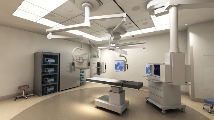 an empty hospital room with medical equipment in the middle and lights on above it,