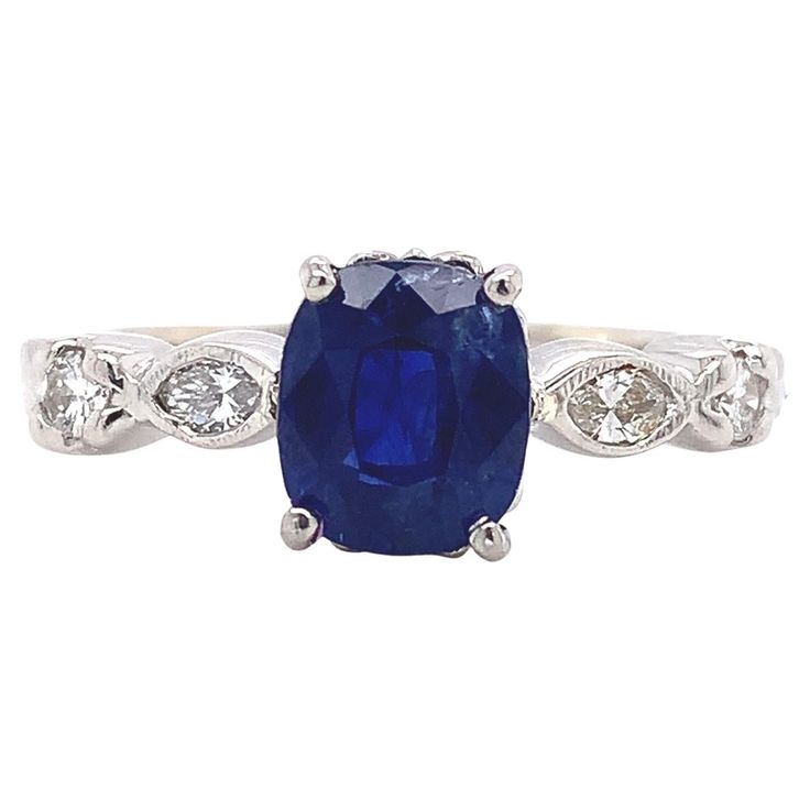 Platinum blue sapphire and diamond ring featuring a rectangular cushion cut sapphire weighing 2.13 carats. The genuine earth mined sapphire has royal blue color. It measures about 7.8mm x 6.6mm. The sapphire is accented by 2 marquise diamonds and 2 round brilliant cut diamonds. The 4 diamonds weigh about 1/4 carat total. The ring fits a size 8 1/4 finger and weighs 3.96dwt. It is contemporary. There are a couple nicks in the sapphire. Rectangular Cushion, Sapphire And Diamond Ring, Royal Blue Color, Shiny Things, Marquise Diamond, Platinum Ring, Ring Fit, Round Brilliant Cut Diamond, Cushion Cut