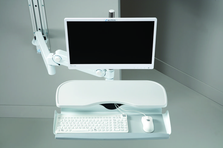 a computer monitor sitting on top of a desk with a keyboard and mouse in front of it