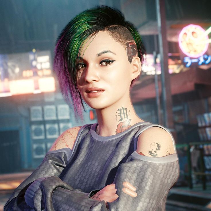 a woman with green hair and piercings standing in front of a neon lit building