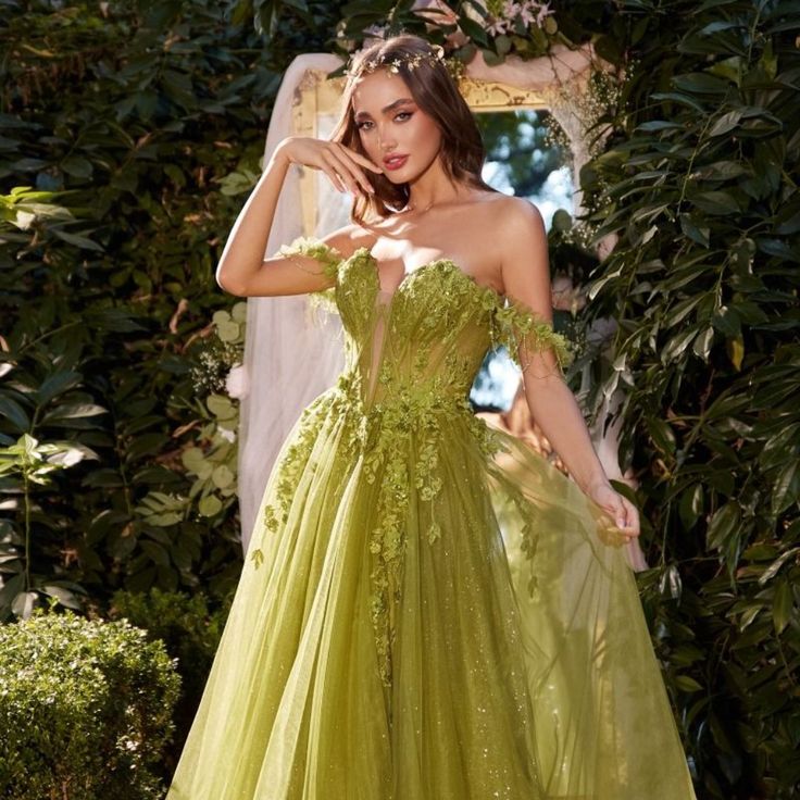 The Evening Dress Made Is High-Quality Tulle Fabric Is Delicately Layered, Creating A Beautiful And Ethereal Effect That Adds A Touch Of Romance To The Dress. The A-Line Skirt Flows Gracefully With Each Step, Allowing For Easy Movement And Adding A Sense Of Drama. Fabric: Tulle Length: Long Color: Leaf Green Neckline: Off Shoulder Silhouette: A-Line Sleeve: Sleeveless Back: Zipper Skirt: Layered Embellishments: Floral Applique, Glitter Occasion: Romantic Date/Evening/Dinner, Wedding/Bridesmaid, Green Lace Ball Gown With Fitted Bodice, Strapless Green Dress With Boned Bodice, Green Dresses With Boned Fitted Bodice, Green Strapless Dress With Boned Bodice, Green Dresses With Boned Bodice, Green Dress With Fitted Bodice, Green Evening Dress With Boned Bodice For Prom, Green Tulle Dress For Gala, Green Lace Ball Gown For Wedding