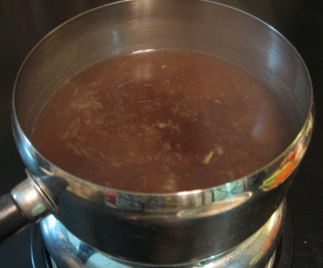 a pot filled with liquid sitting on top of a stove