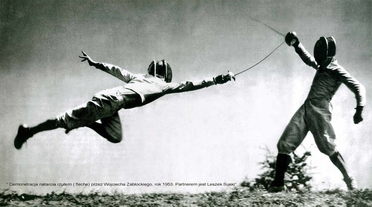 two men are jumping in the air while holding hands