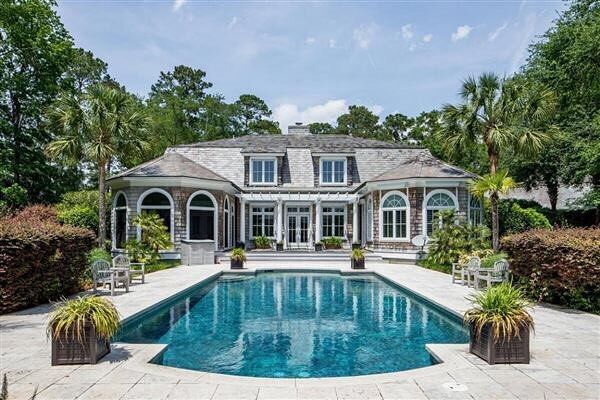 a house with a pool in front of it