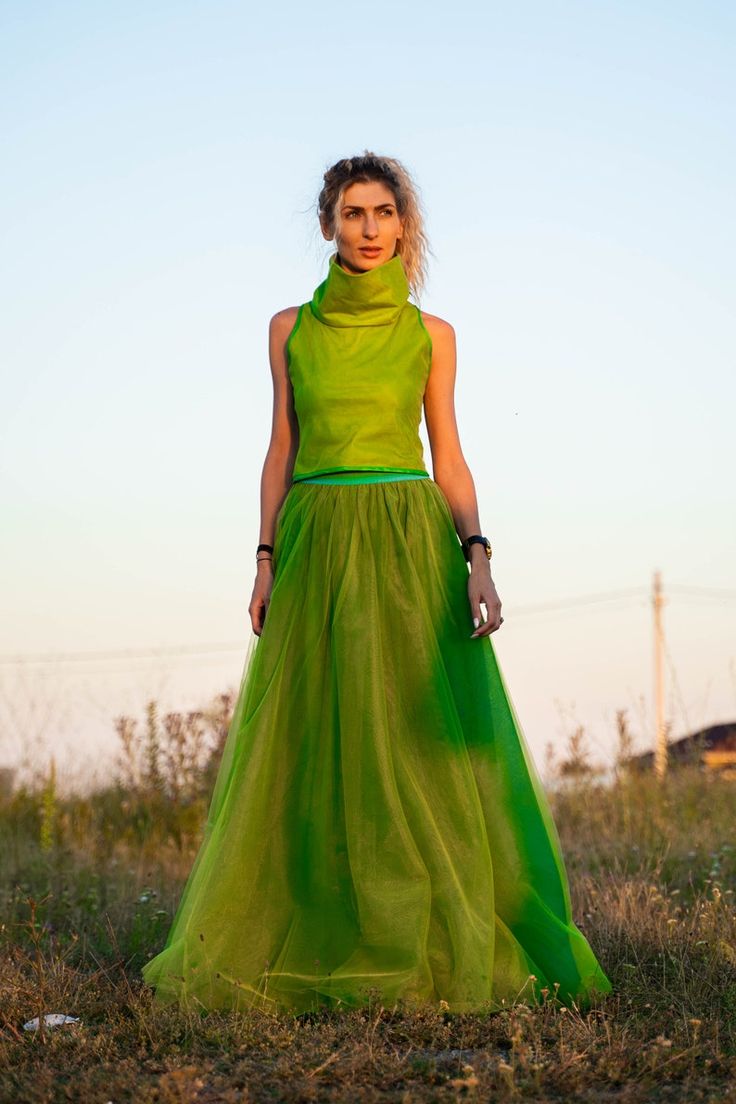 Avant-garde Fitted Skirt For Summer, Chic Green Dress With Voluminous Skirt, Green Voluminous Tiered Maxi Skirt, Green Voluminous Maxi Skirt For Spring, Green Dresses With Flowy Skirt, Green Relaxed Full Maxi Skirt, Green Voluminous Long Skirt, Chic Voluminous Green Skirt, Chic Green Voluminous Maxi Skirt