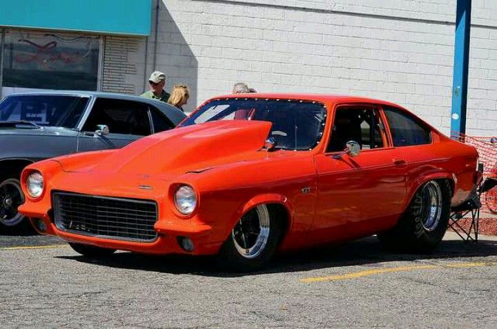 an orange car parked in front of a building