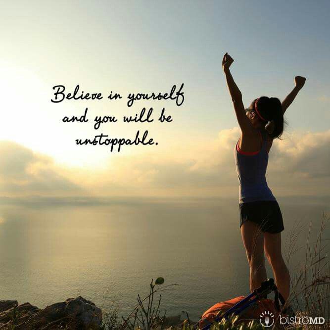 a woman standing on top of a hill with her arms up in the air and an inspirational quote above her