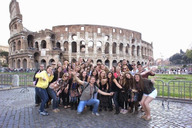 a group of people posing in front of the colossion