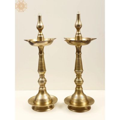 When a devotee's prayers are granted, he or she typically presents a light to the god in question, which is known as dev danam. A votive offering is shaped like a lamp. It is recommended to associate the lamp with some spiritual imagery to boost its auspiciousness and to complete the lamp's identification as a heavenly vehicle for transmitting prayers. This brass statue with a single lamp and a crown embellished with a peacock picture is said to be a perfect Dev Deepam. It is used not just as a… Peacock Lamp, Peacock Pictures, Brass Statues, Curtain Accessories, Book Art Drawings, Brass Metal, Garden Lighting, Pink Yellow, Lighting Fixtures