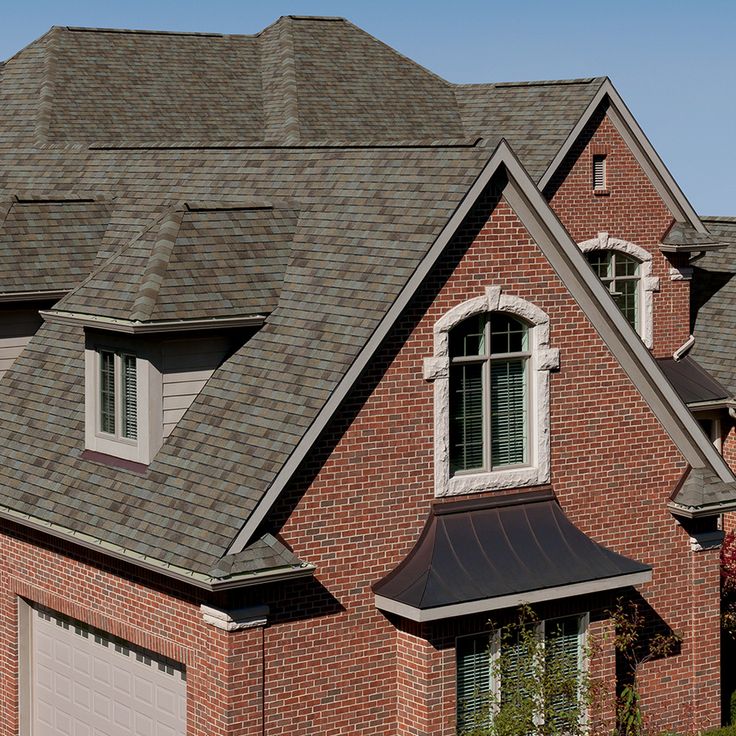 a large brick house with two garage doors