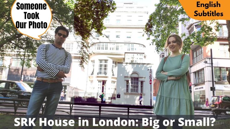 two people standing next to each other in front of a building with the words srk house in london big or small?