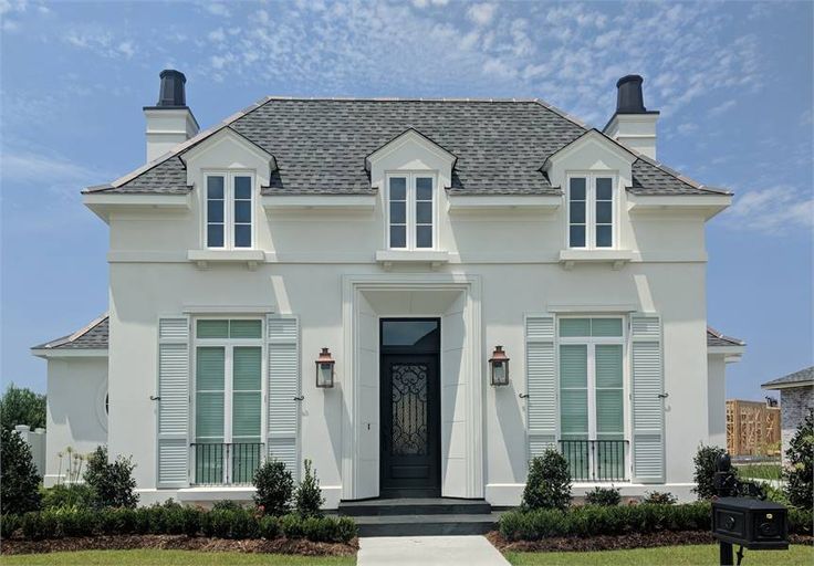 a white house with black shutters on the front