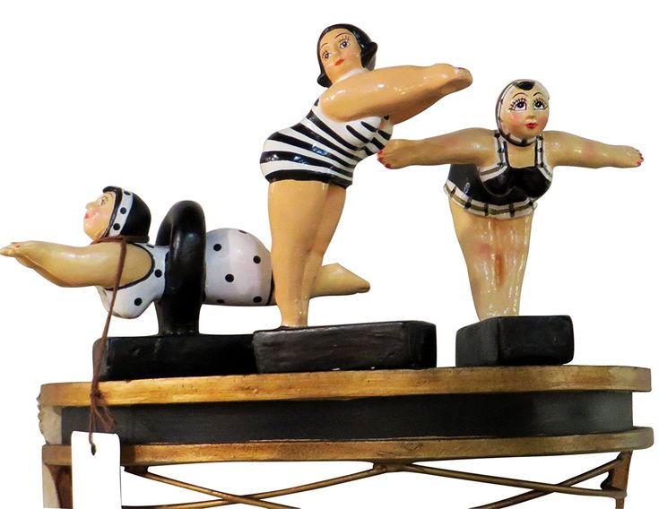 two figurines are shown on top of each other, one is doing a handstand