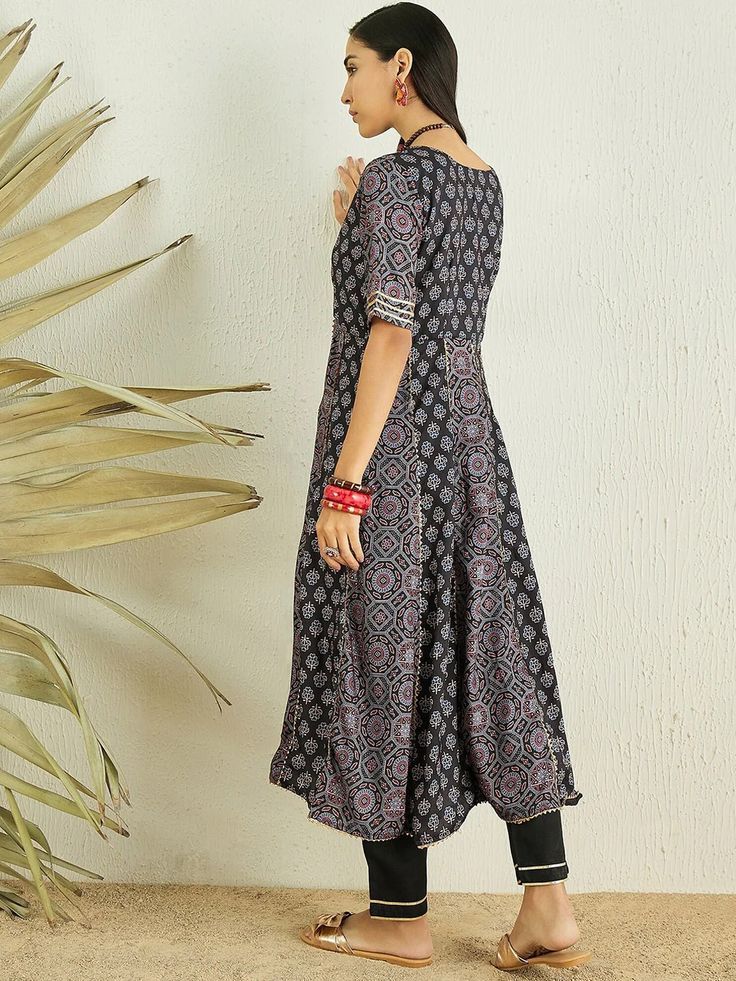 Discover the perfect blend of elegance and comfort with our Black Floral Printed Anarkali Gotta Patti Kurta with Trousers. Adorned with a beautiful floral print and exquisite gotta patti detailing, this Anarkali kurta boasts a v-neck and short regular sleeves for a classic look. The cotton blend machine weave fabric en Unstitched Black Anarkali Lawn Suit, Anarkali Style Black Kurta With Block Print, Black Straight Kurta Anarkali Set With Printed Motifs, Black Semi-stitched Anarkali Lawn Suit, Black Semi-stitched Anarkali Set With Floral Embroidery, Western Kurtis, Kaftan Kurta, Anarkali Kurta, White Kurta