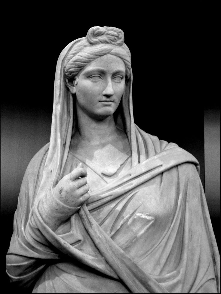 black and white photograph of a statue of a woman with her hands folded over her chest