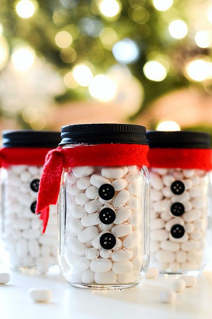 three mason jars filled with white and black candies