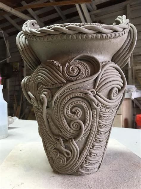 an intricately designed vase sitting on top of a table