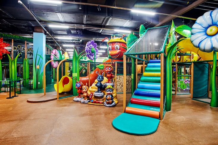 children's play area with colorful slides and flowers