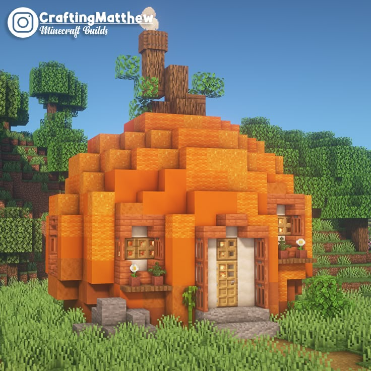 an orange house made out of blocks in the middle of a field with trees and bushes