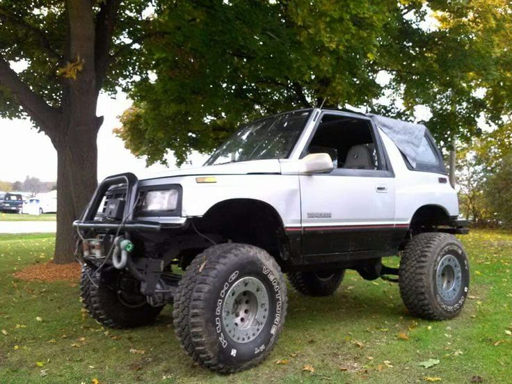 an off - road vehicle is parked in the grass