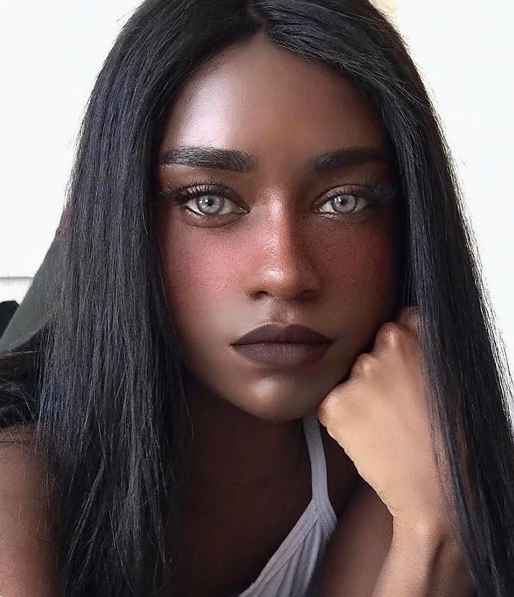 a woman with long black hair and makeup looks at the camera while posing for a photo